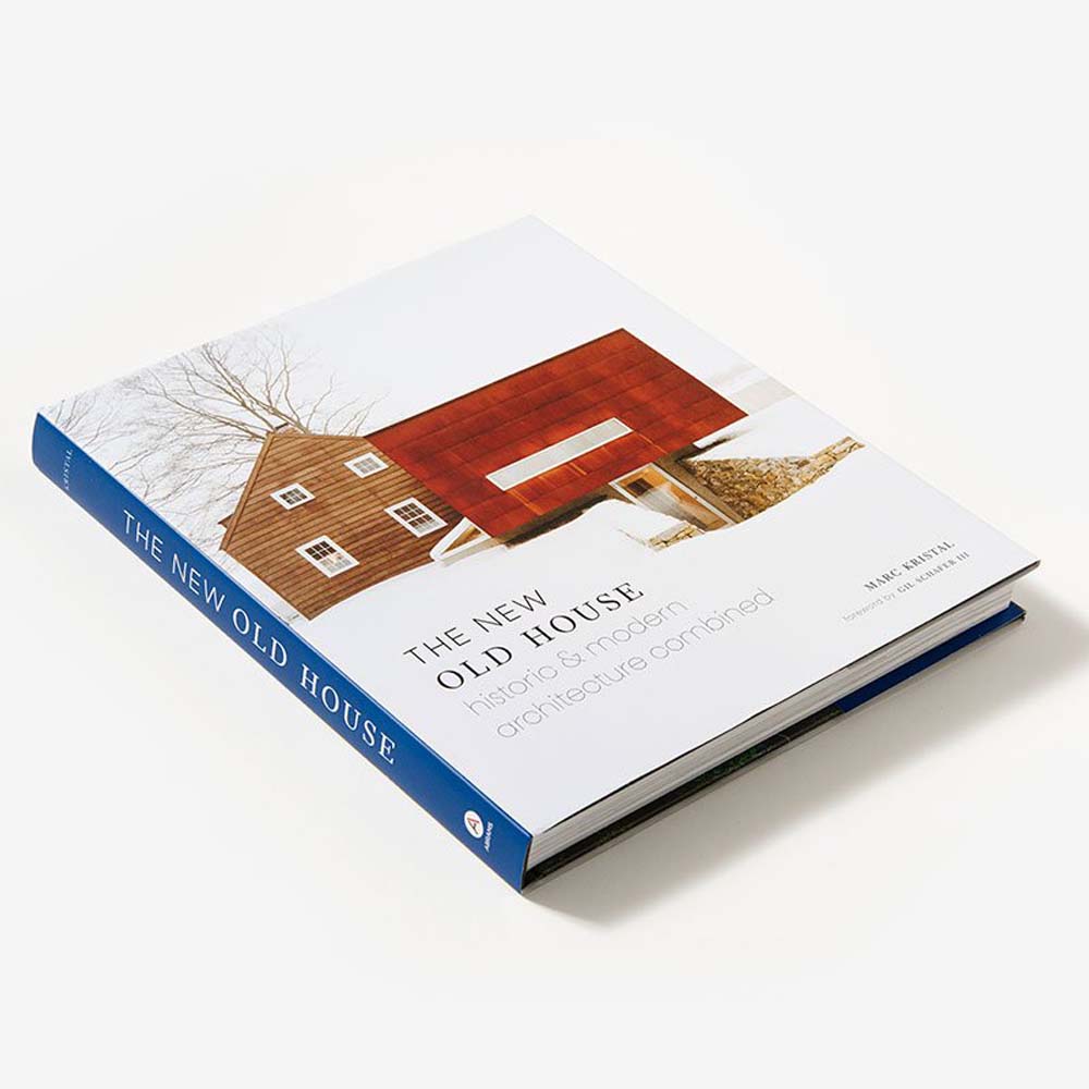 Front cover of book: The New Old House historic and modern architecture combined showing a brown sided house and modern red barn