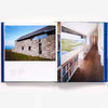 Interior pages of book: The New Old House historic and modern architecture combined showing a hallway with bookcase and large window
