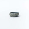 Small hand carved stone bowl on a white background