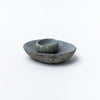 Large and small stone bowls stacked on top of each other on a white background