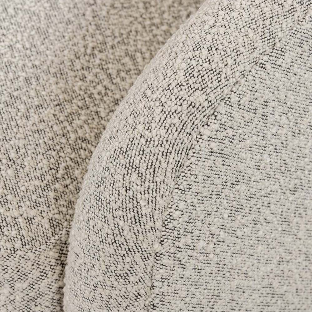 Close up of fabric on Four hands brand Topanga swivel chair with boucle grey and creme fabric on a white background