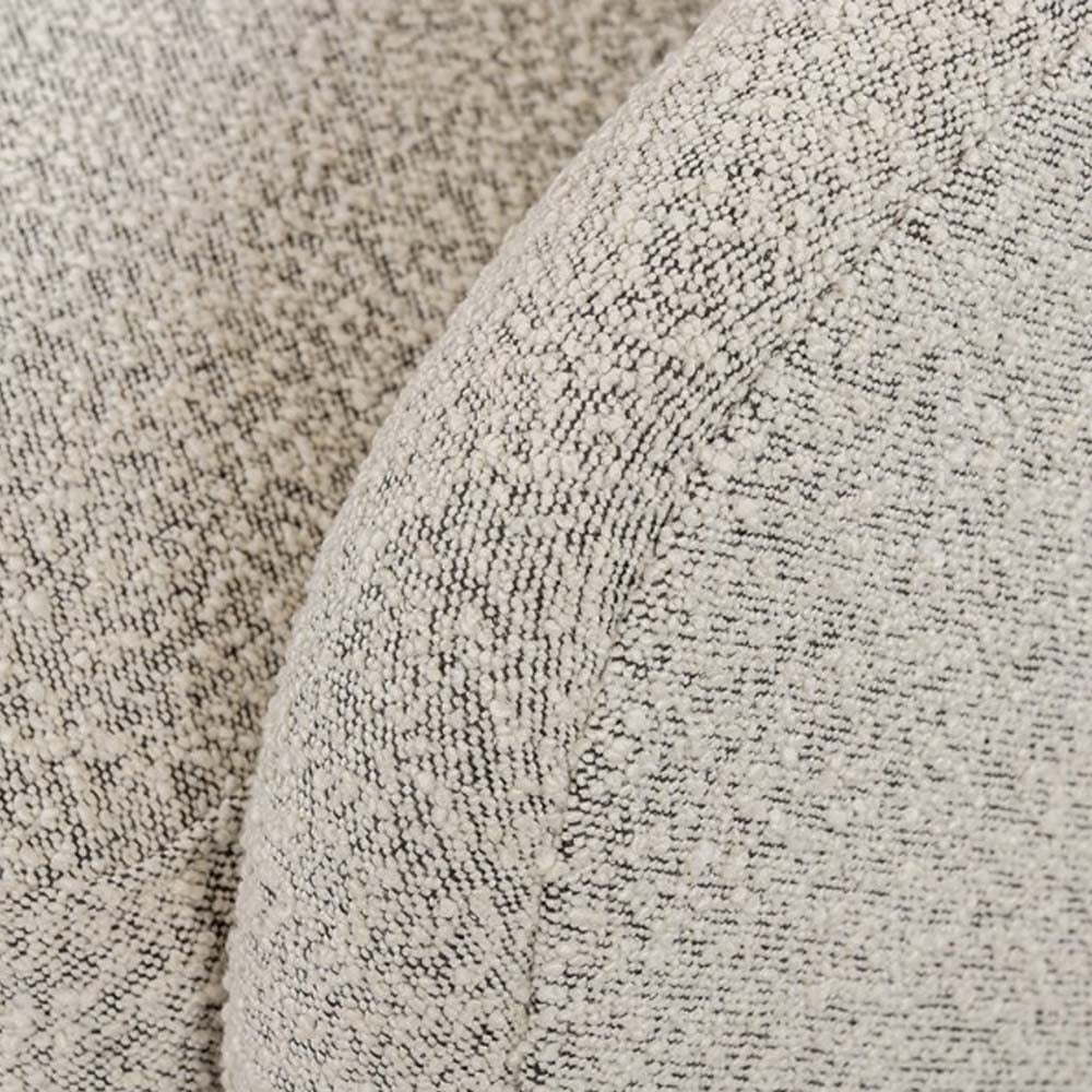 Close up of fabric on Four hands brand Topanga swivel chair with boucle grey and creme fabric on a white background