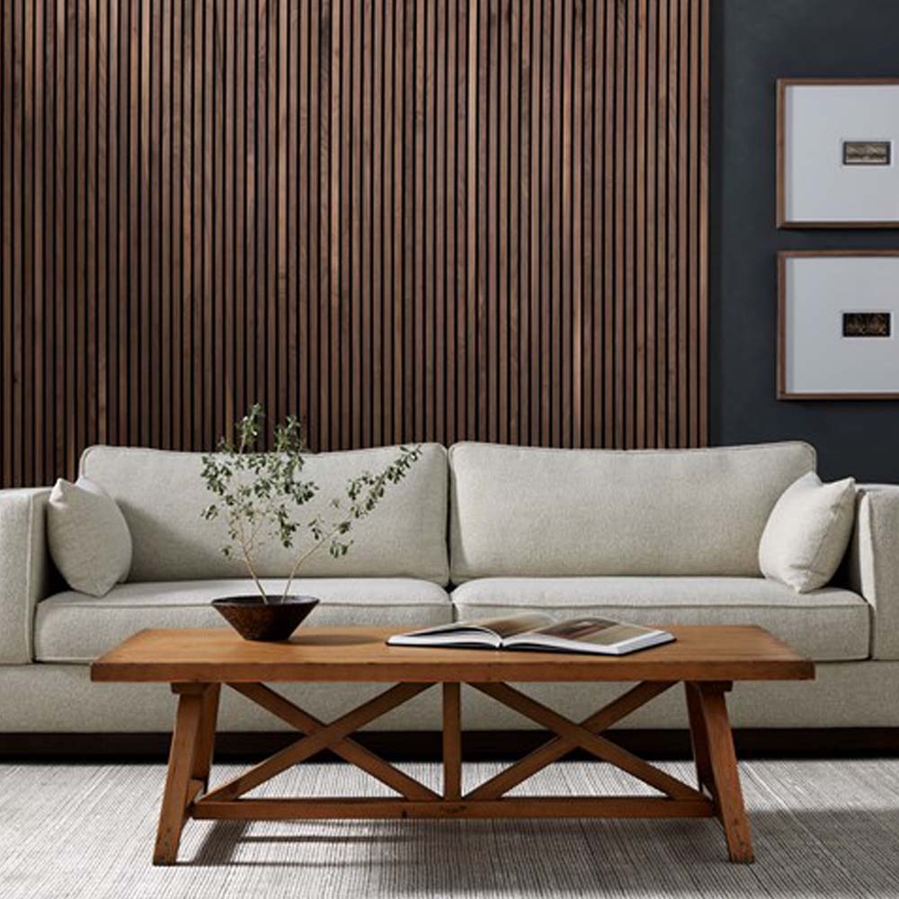 Living room with cream sofa wood walls and charcoal paint with Waxed pine 'Trellis' rectangular coffee table by four hands furniture on beige rug