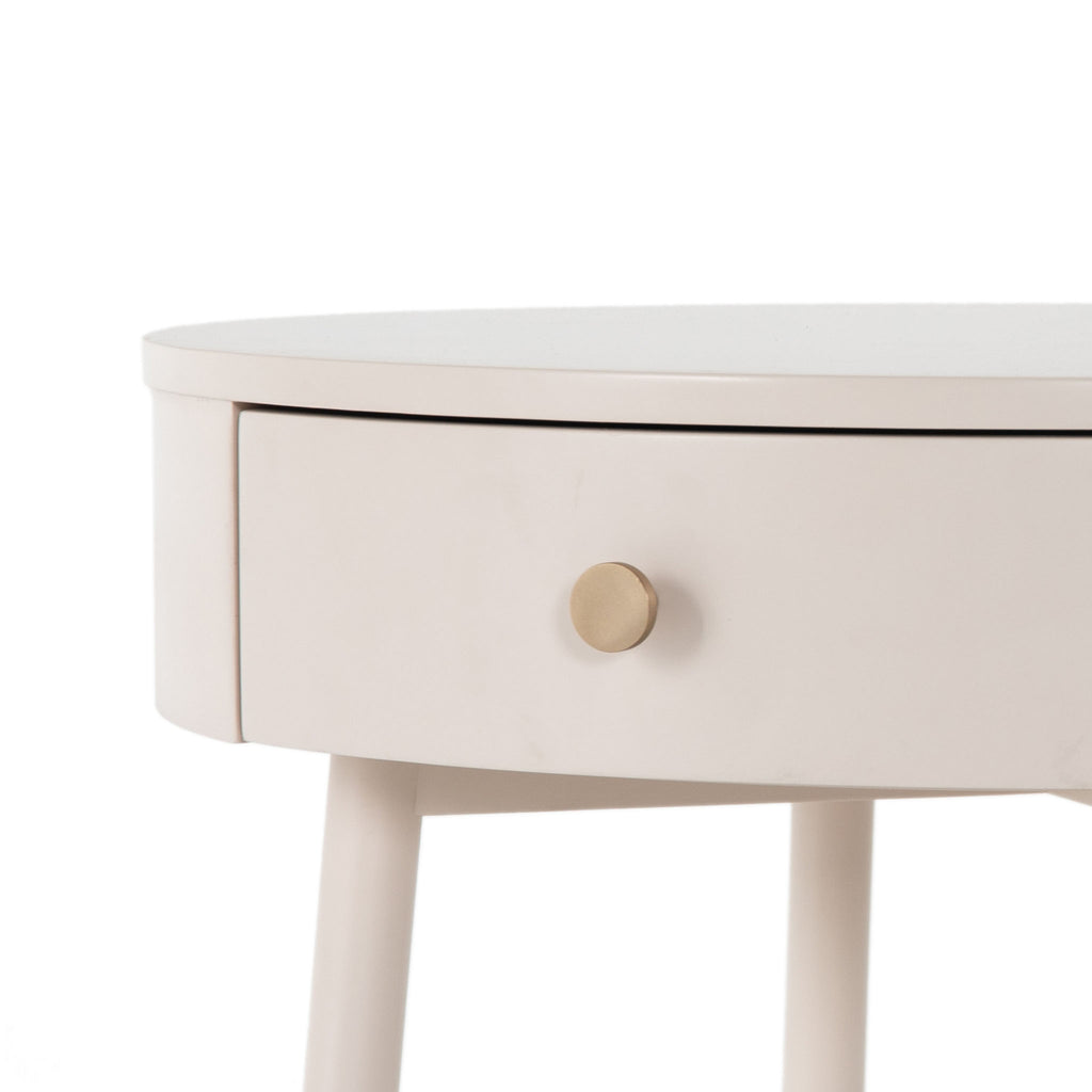 Close up of knob and drawer on White round 'van' side table with shelf and drawer  by four hands furniture on a white background