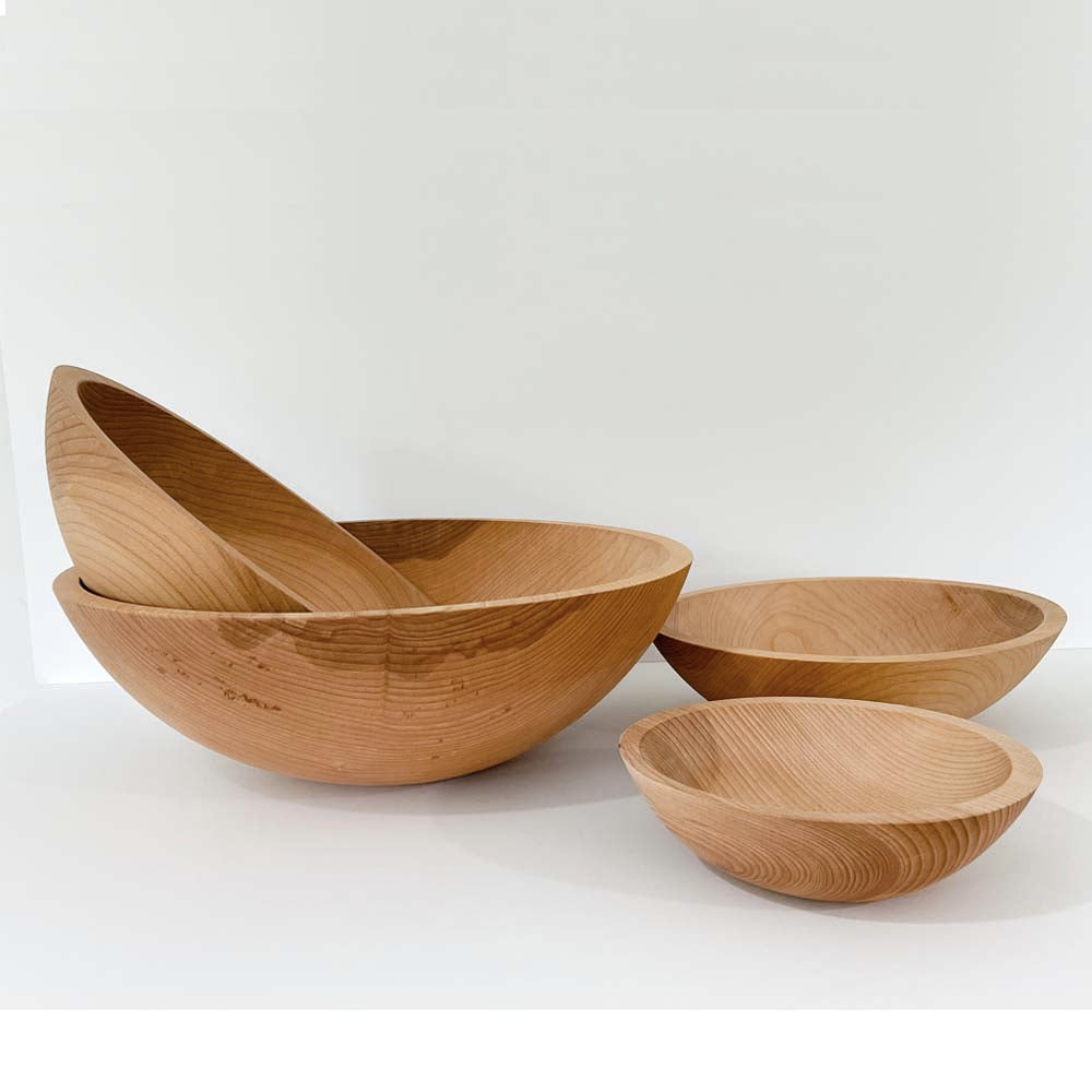 Four beech salad bowls displayed on a white background