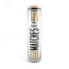 White tip fireplace matches in glass container with wood top on white background