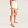Model wearing Z Supply White V-Neck Terry Short in front of a creme background