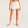 Model wearing Z Supply White V-Neck Terry Short in front of a creme background