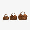 Three Seagrass Baskets with Leather Handles on a white background