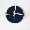 Set of four navy woven round placemats with white border
