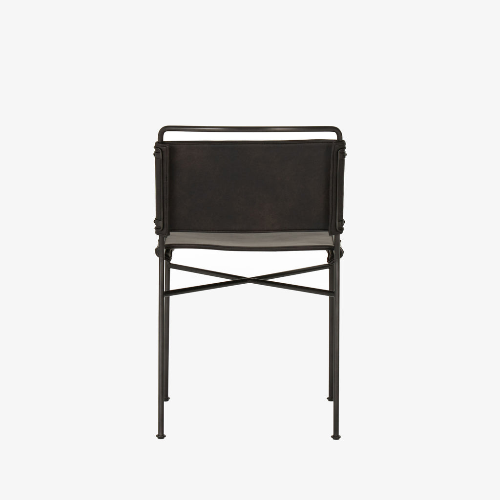 Back view of Four hands brand wharton chair with black iron frame and black leather seat on a white background