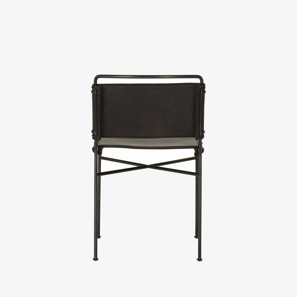 Back view of Four hands brand wharton chair with black iron frame and black leather seat on a white background