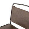 Close up of Four hands brand wharton chair with black iron frame and dark brown leather seat on a white background