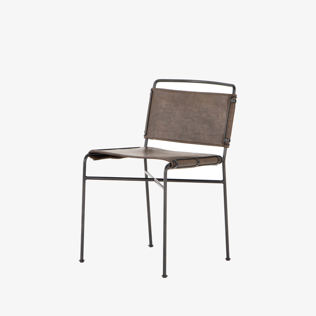 Four hands brand wharton chair with black iron frame and dark brown leather seat on a white background