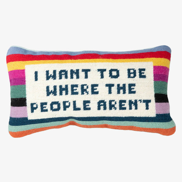 Needlepoint pillow with saying 'I want to be where the people aren't' on a white background