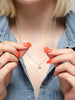 Scream Pretty brand opal spike pendant on model with denim shirt 