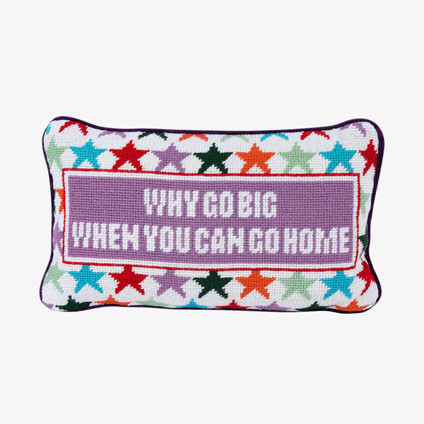 Embroidered pillow with stars and saying 'why go big when you can go home' on a white background