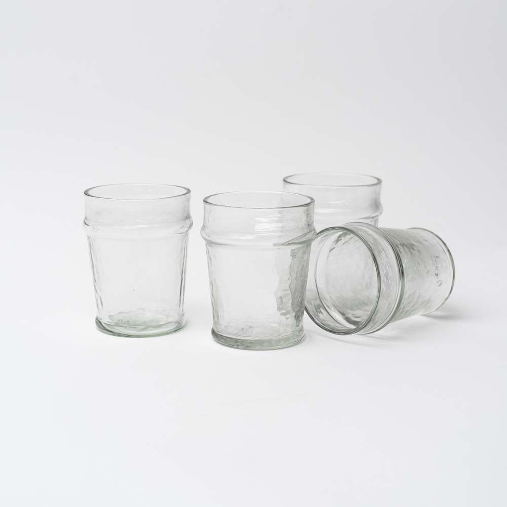 Four hand blown drink glasses on a white background