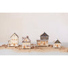 Laser cut LED light up wood buildings on a white background