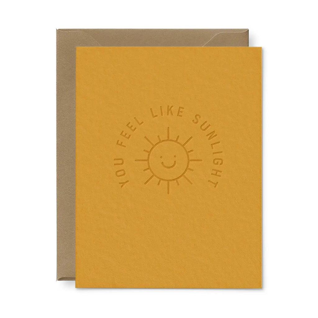 yellow greeting card with saying 'you feel like sunlight' on a white background 