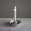 Stoneware candle holder on a wood surface